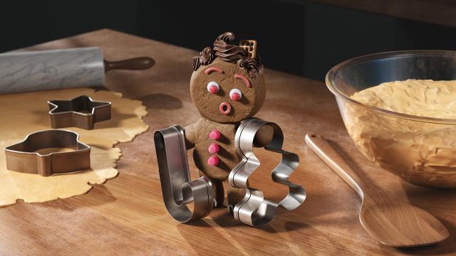 Gingerbread character holds up two cookie cutters