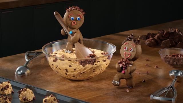 Gingerbread characters mixing cookie dough 